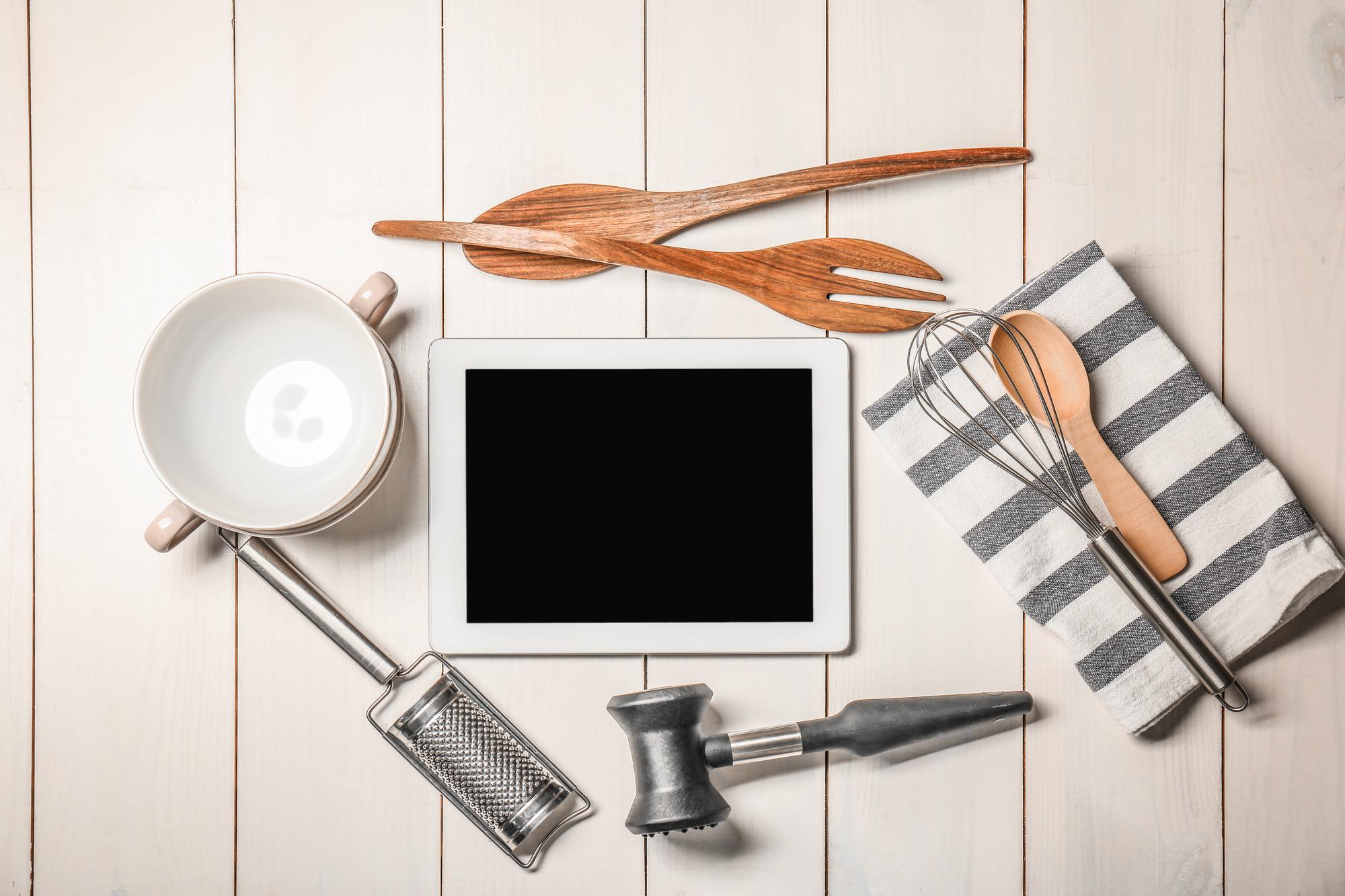 Workspace with cooking tools and a tablet showing a recipe